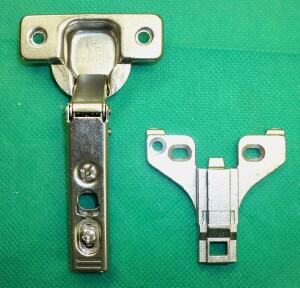 Typical long arm or clip on concealed hinge with face frame mounting plate