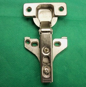 Typical long arm or clip on concealed hinge with face frame mounting plate attached